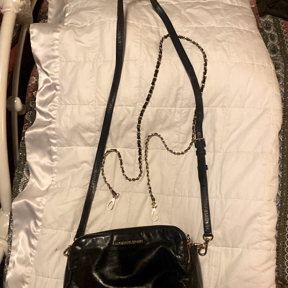 Michael Kors cross body with two straps black leather. The bag is 10 by 7